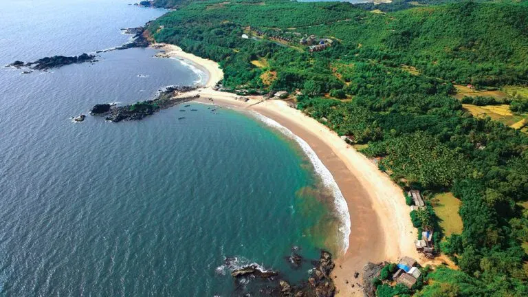 Iconic Om Beach double crescent bay and rocky shoreline in Gokarna