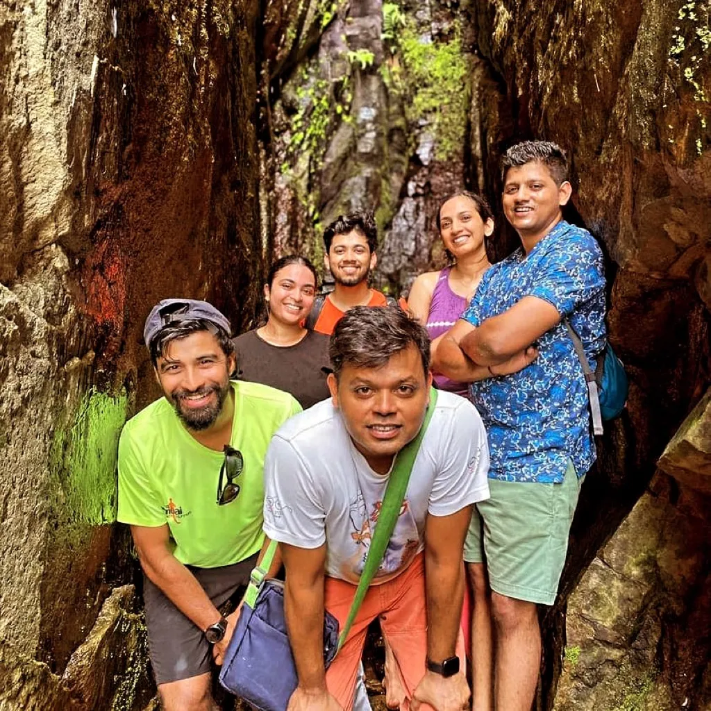 Excited trekking group exploring the dramatic rock canyon of Yana Caves