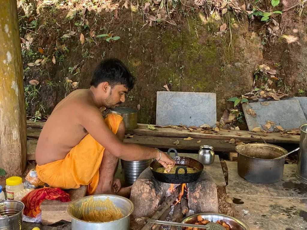 Traditional preparation of sacred temple prasadam over wood-fired chulha